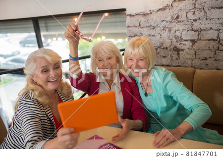 Good-looking aged ladies having a video call and looking excited Good-looking aged ladies having a video call and looking excited 81847701