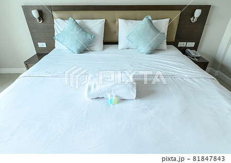 View of comfortable bed in hotel bedroom decoration in cozy style. Conceptual of a room in a home where people sleep. View of comfortable bed in hotel bedroom decoration in cozy style. Conceptual of a room in a home where people sleep. 81847843