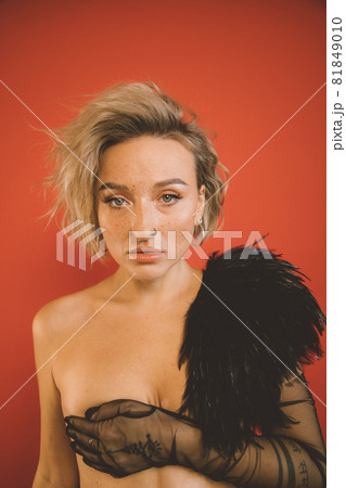 Naked woman with nude make up wearing boa Naked woman with nude make up wearing boa 81849010