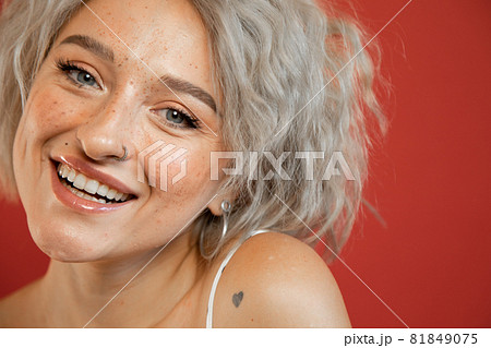 Woman smiling widely and looking happy Woman smiling widely and looking happy 81849075