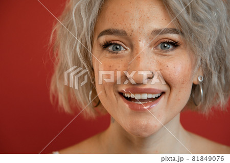 Woman smiling widely and looking happily Woman smiling widely and looking happily 81849076