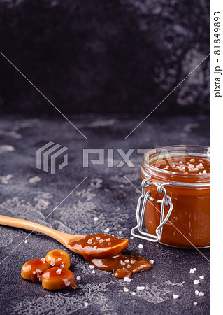 Glass jar with tasty delicious salted caramel 81849893