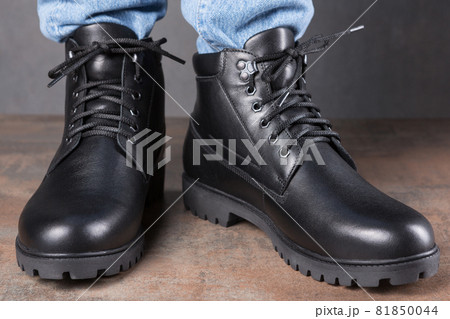 men's shoes on the feet, on the grunge surface, front view, close-up shot men's shoes on the feet, on the grunge surface, front view, close-up shot 81850044