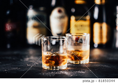 Whiskey with ice on a dark table 81850344