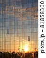 Sunset and clouds reflected in the glass facade of a skyscraper. 81858300
