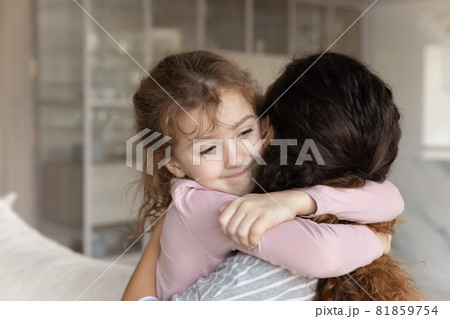 Adorable little kid girl embracing affectionate young mother. Adorable little kid girl embracing affectionate young mother. 81859754