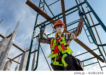 Workers wearing safety uniforms working at height at construction site Workers wearing safety uniforms working at height at construction site 81861649
