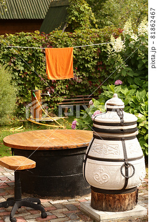 beautiful formal garden with dining place, table tandoor bench  81862467
