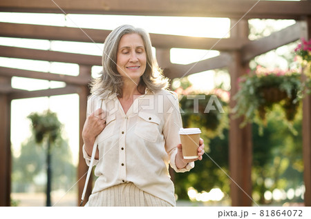 Adult woman enjoying walk in park 81864072