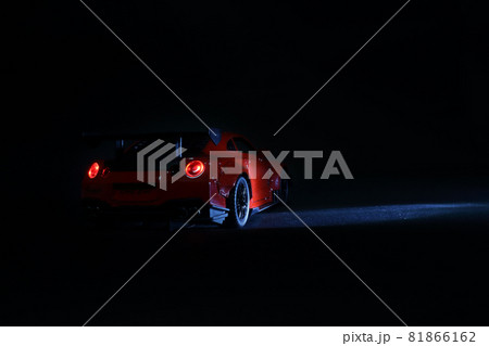 Modern red sports car metallic on black 81866162