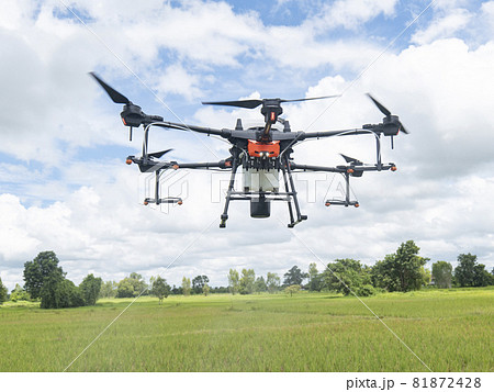Agricultural drones make flights to prepare to spray rice fields. Agricultural technology smart farm concept. 81872428