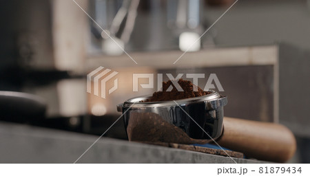 fresh ground coffee in basket of bottomless portafilter 81879434