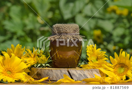 Jar of honey on wooden table 81887569