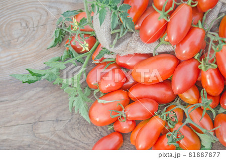 Fresh, ripe tomatoes on wood background 81887877