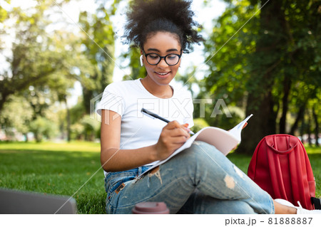 African Student Girl Learning Using Laptop And Taking Notes Outdoor 81888887
