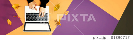 Autumn leaves with person using a laptop computer Autumn leaves with person using a laptop computer 81890717
