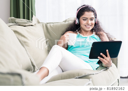 Woman watching videos on digital tablet 81892162