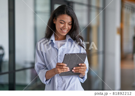 Happy woman working with modern gadget in office Happy woman working with modern gadget in office 81892212