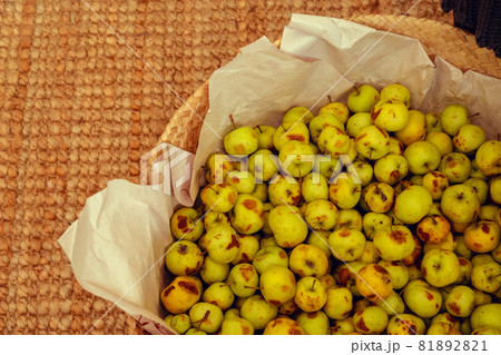 Basket with small green apples close up 81892821