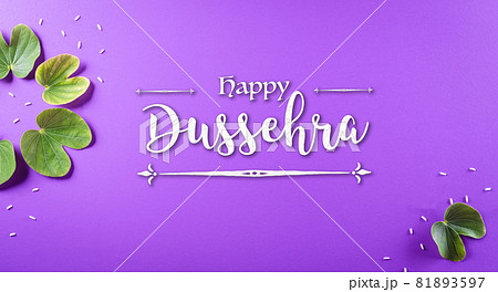Happy Dussehra. Green leaf and rice with the text on purple pastel background. Dussehra Indian Festival concept. 81893597