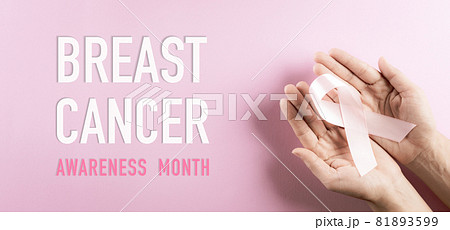 Hands holding pink ribbon, Breast cancer awareness, symbolic bow color raising awareness on women's breast tumor. Healthcare, medicine and breast cancer awareness concept. 81893599