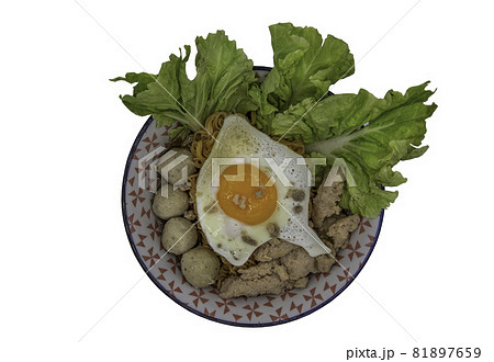 Boil egg noodles with pork ball, minced pork, fried egg and vegetables isolated on white background with clipping path. Boil egg noodles with pork ball, minced pork, fried egg and vegetables isolated on white background with clipping path. 81897659