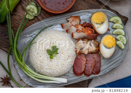 Red pork with rice : Thai Style Red Barbecue Pork, duck egg and crispy pork belly, sliced cucumber with red sauce and broth. Red pork with rice : Thai Style Red Barbecue Pork, duck egg and crispy pork belly, sliced cucumber with red sauce and broth. 81898219
