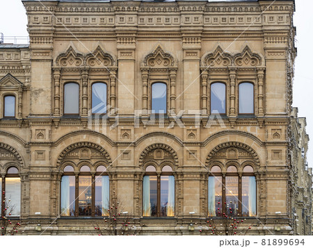 Fragment of the facade of a building with windows of the 19th century in the classicism style. Fragment of the facade of a building with windows of the 19th century in the classicism style. 81899694