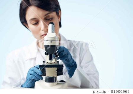 woman looking through a microscope laboratory research science experiment woman looking through a microscope laboratory research science experiment 81900965