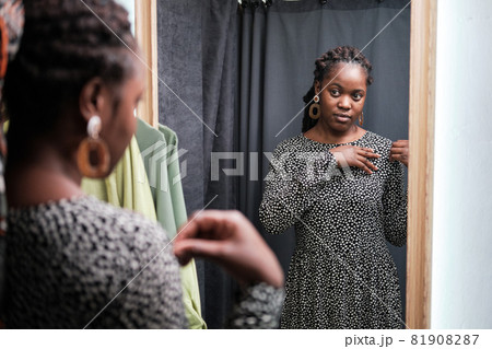 Woman trying on new dress 81908287