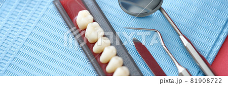 Dental set and dental instruments lie on table closeup Dental set and dental instruments lie on table closeup 81908722