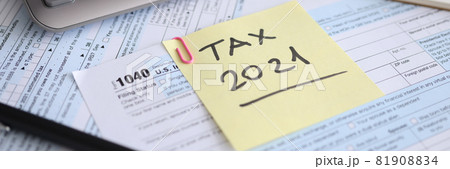 Tax form for 2021 and calculator with pen are on t table Tax form for 2021 and calculator with pen are on t table 81908834