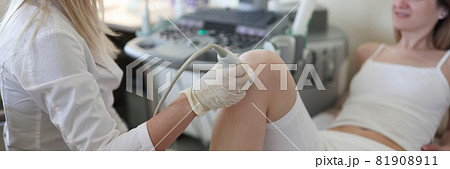Doctor performs ultrasound examination of patient leg Doctor performs ultrasound examination of patient leg 81908911