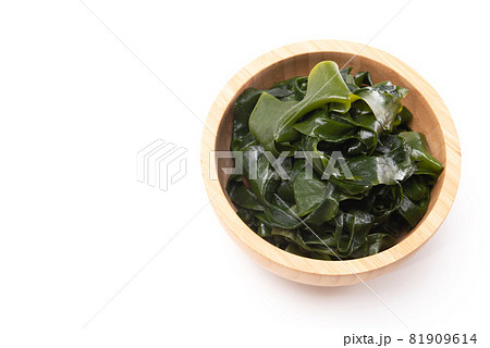 Top view of fresh seaweed wakame in wooden bowl isolated on white background. Healthy japanese food Top view of fresh seaweed wakame in wooden bowl isolated on white background. Healthy japanese food 81909614
