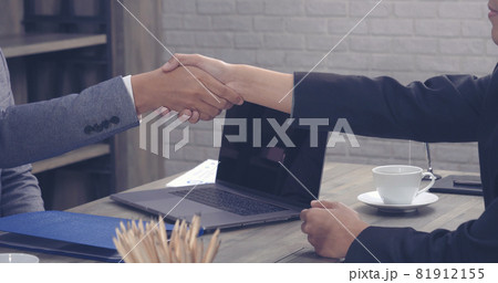 Team Business Partners shaking hands together to Greeting Start up new project. Shakehand Teamwork Partnership at office desk. Businessman partners handshake together.  Business concept 81912155