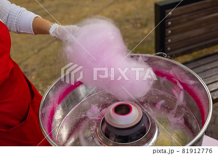 People make cotton candy for children close-up. People make cotton candy for children close-up. 81912776