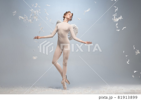 Full-length portrait of beautiful graceful ballerina dancing in image of angel with wings isolated on gray studio background. Art, motion, action, flexibility, inspiration concept. 81913899