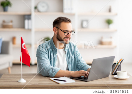 Millennial male tutor with laptop teaching Turkish online from home Millennial male tutor with laptop teaching Turkish online from home 81914611