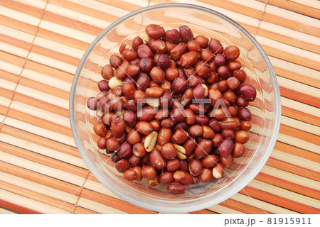 Processed pea nuts in a bowl on table top down . Processed pea nuts in a bowl on table top down . 81915911