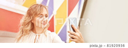 Young woman doing self portrait outside. City vacation portrait. Blogger selfie 81920936