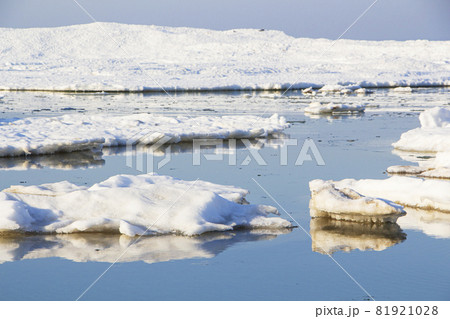 Close-up of a large piece of ice in blue water. Global warming, melting glaciers. Close-up of a large piece of ice in blue water. Global warming, melting glaciers. 81921028
