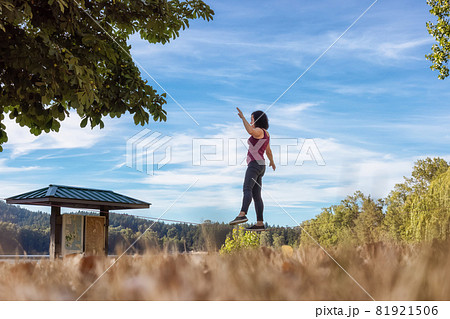 Adventurous White Caucasian Adult Woman Walking on Slackline 81921506