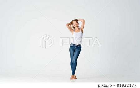 pretty blonde in jeans barefoot posing fashion isolated background pretty blonde in jeans barefoot posing fashion isolated background 81922177