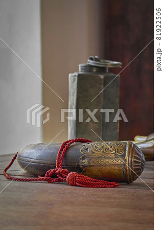 Copper hunting horn is lying on the wooden table. Antique medieval European hunting horn with patterns. Copper hunting horn is lying on the wooden table. Antique medieval European hunting horn with patterns. 81922506
