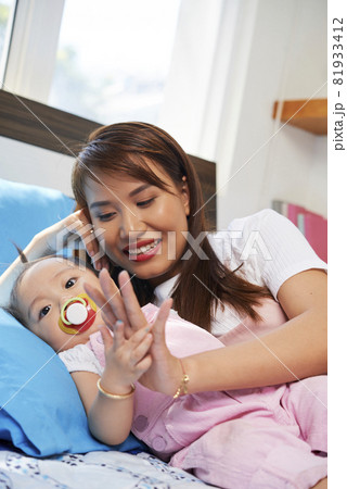 Young Woman Looking at at Little Daughter Young Woman Looking at at Little Daughter 81933412