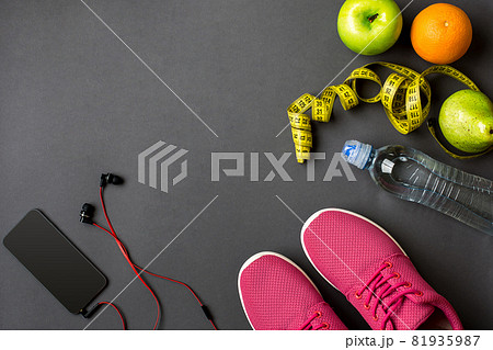 Workout plan with fitness food and equipment on gray background, top view Workout plan with fitness food and equipment on gray background, top view 81935987