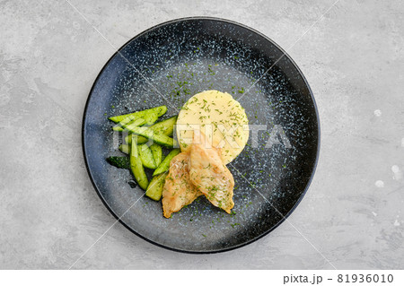 Top view of fried zander fillet with mashed potatoe and pickled cucumber Top view of fried zander fillet with mashed potatoe and pickled cucumber 81936010