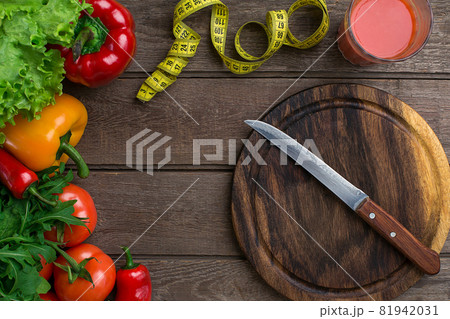 Sport and diet. Vegetables and centimeter. Peppers, tomatoes, salad on rustic background Sport and diet. Vegetables and centimeter. Peppers, tomatoes, salad on rustic background 81942031
