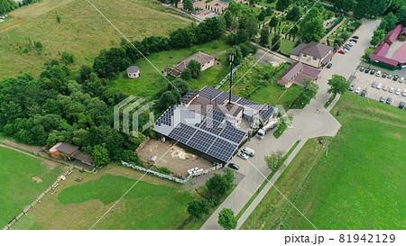 New solar farm under the blue sky. Workers in special outfit walk and talk about sunny cells installation. Modern solar panels produce clean electricity. Technicians installing solar panels 81942129