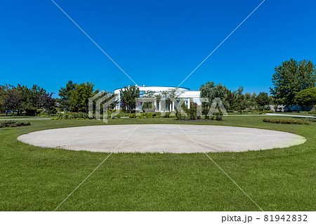 Private helipad on green lawn on background of luxury country house on summer day 81942832